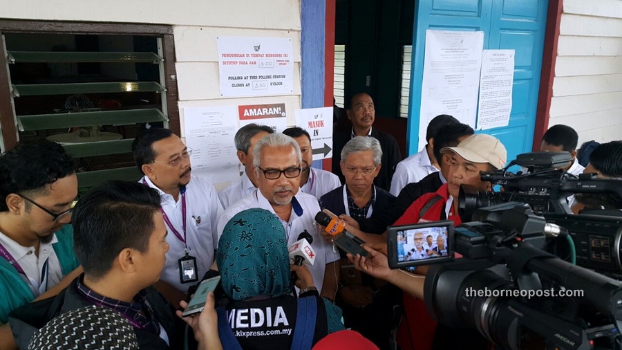 Mohd Hashim being interviewed by reporters at the Kampung Sungai Lundu community hall.