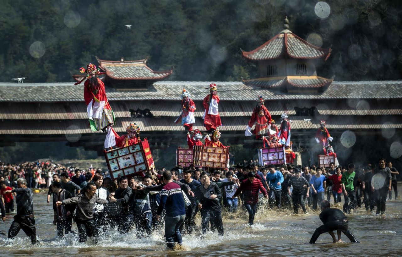 Hakka children are carried in palaquins to honour the now-legendary figures Tu Dalang and Lai Balang who established Tufang as a new village free of child sacrifice. AFP Photo