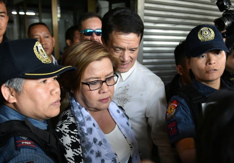 Philippine Senator Leila De Lima (C), a top critic of President Rodrigo Duterte, is escorted by police officers and her lawyer Alex Padilla (R) after her arrest at the Senate in Manila on Feb 24, 2017. AFP Photo