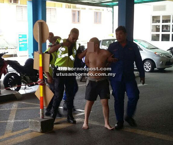 The deranged man being brought to Sarawak General Hospital following the assault on his elder brother.