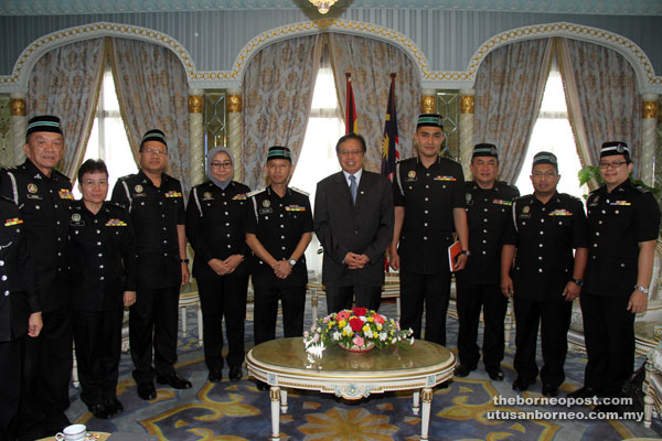 Abang Johari (fifth right) in a group photo with Leben (fifth left) and a team from the Immigration Department who come for a courtesy visit to the Chief Minister’s Office. — Photo by Chimon Upon