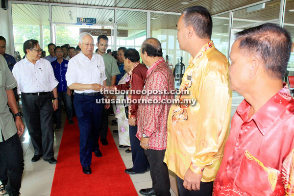 Najib shakes hands with local community leaders during the send-off at KIA. On Najib’s right is Abang Johari.