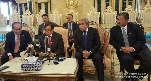 Abang Johari (front row, second left) reading out his statement during a press conference at his office in Wisma Bapa Malaysia yesterday. He was accompanied by (from seated left) Uggah, Awang Tengah, Morshidi, (back row, from left) Sudarsono and Sapuan.