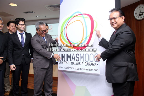Nanta (right) and Kadim (second, right) launching the Unimas MOOC at Unimas’ Centre of Teaching Facilities 3 (CTF3) yesterday. Also seen is Adam (left). — Photo by Chimon Upon