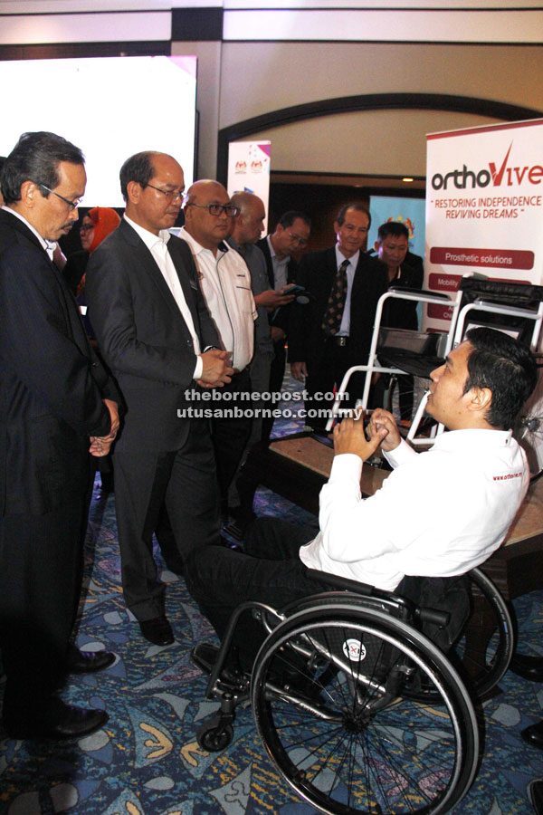 Madius (second left) is briefed on Orthovive during the product launching.