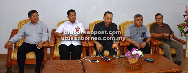 Penguang (centre) talks to the press.