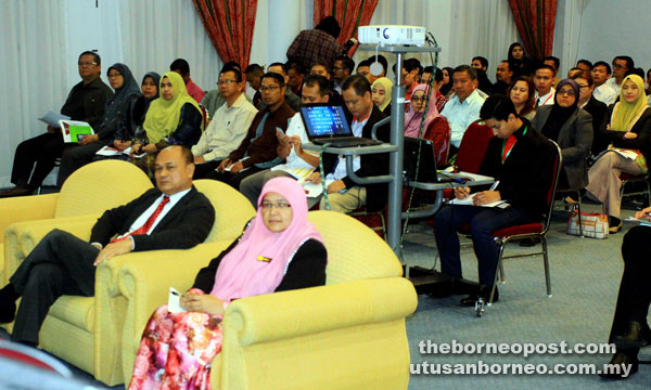 Tengku Azmi seated (front left) and Waila and other participants at the briefing. — Photo by Jeffery Mostapa