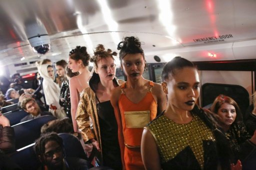 Models display Amanda Mehl's creations inside a school bus during the New York Fashion Week, on February 13, 2017. - AFP Photo