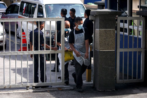Two forensics staff walk out of the Forensics Department of Kuala Lumpur Hospital where Kim Jong Nam’s body is being kept.  — Bernama photo