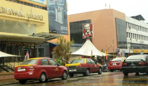QUEUING UP: Taxis taking turns to pick up passengers from a shopping arcade in the business district of Kuching city.