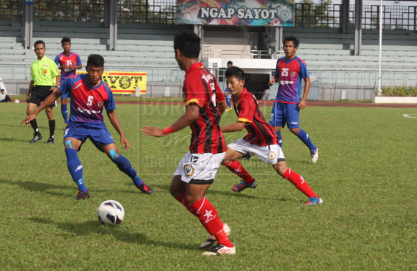 WHAT’S GOING ON?: File photo of the Sarawak (in red and white) versus Johor in a President’s Cup match recently.