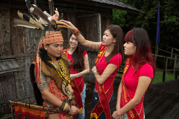 IS IT REAL?: Contestants take a look at a traditional headdress.