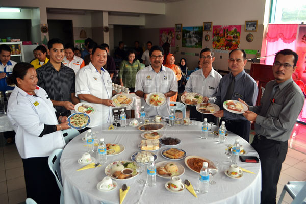 AFFORDABLE DISHES: (From third left) Dahim and Wan Uzir join others to show dishes on offer under the 1Malaysia People’s Menu. 