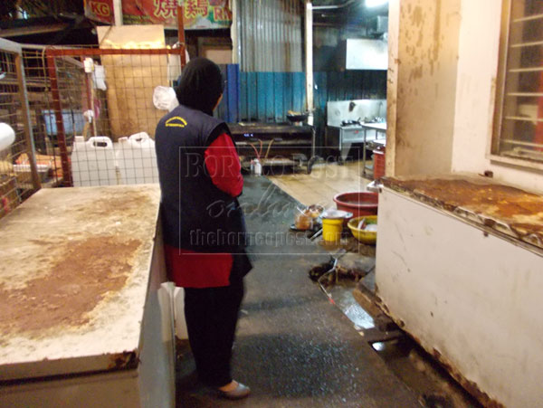 TOO DIRTY: Enforcement officer checking the dirty kitchen.