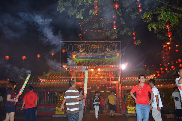 RECIPROCATING: Worshippers offer burnt incense for blessings received in the Year of the Dragon.