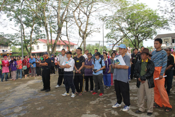 ALL EARS: Local residents listening to a briefing prior to the cleaning campaign.