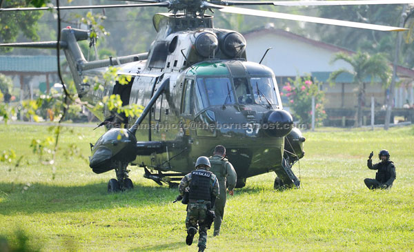 OFF TO THE FRONTLINE: Armed Forces commandos board a Nuri helicopter for deployment to Kampung Tanduo for the offensive.  — Bernama photo
