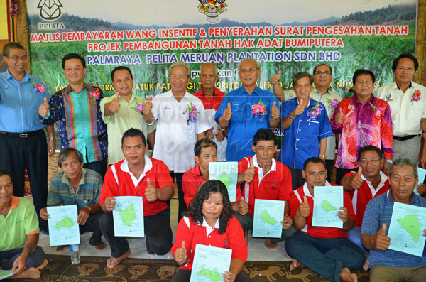 WORTHY VENTURE: Jabu (standing fifth right), Masing (fourth left) and Entulu (third left) and others in a group photo with some of the land owners after they have received their land confirmation letters. 