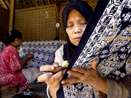 ENFORCING TRADITION: Photo shows women making batik. Mustapa says the batik industry needs serious attention and a strategic development plan come 2020. — Reuters photo 
