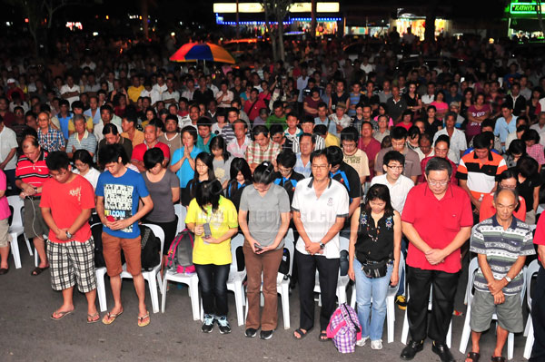 REMEMBERING THE SACRIFICES: The crowd standing silence to honour the nation’s fallen servicemen in Sabah. 