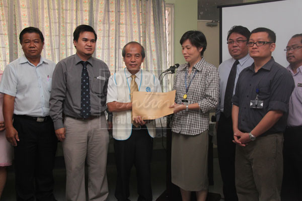 FOR BETTER CARE: So (third left) hands over a CCTV sponsorship to Dr Ngieng while Dr Razjeh (second left) and others look on.