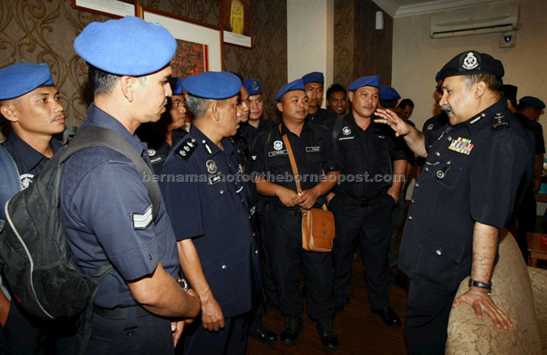 BOOSTING MORALE: Mokhtar (right) greets Marine Operation Force personnel involved in Ops Daulat in Lahad Datu on their return. — Bernama photo