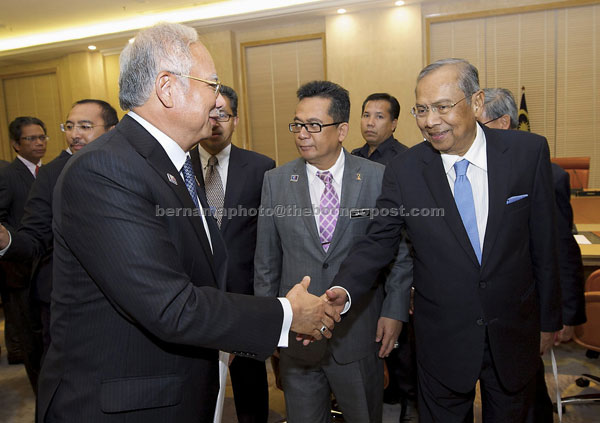 Najib (left) shaking hands with Adenan (right) after chairing the 121st Meeting of Menteris Besar and Chief Ministers at the Perdana Meeting Room, Bangunan Perdana Putra in Kuala Lumpur yesterday. — Bernama photo