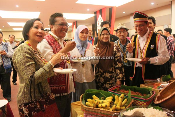 Mohamad Kadim (second left) samples traditional delicacies accompanied by senior staff and guests.