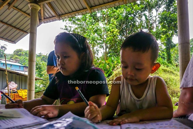 Children from Kampung Sapit rushing to finish their homework before nightfall. — Photo courtesy of University of Nottingham