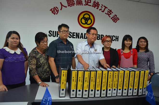 Lee (centre) and party staff showing the records that are open for the public to view.