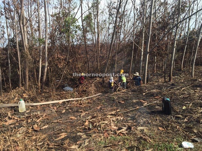 Naim staff check the area to ensure the fire has been extinguished.