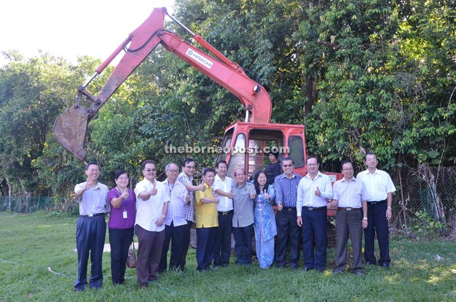 Dr Sim (sixth left) is seen during a photo call for the earth-breaking ceremony. 