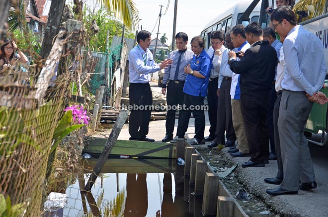 Dr Jerip (third left) listens to an explanation by a staff of Sibu Health Office (left) during a site inspection at Belian Lane.   