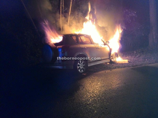 The car burning after ramming a streetlight at Jalan Padang Kerbau at about 10.30pm.