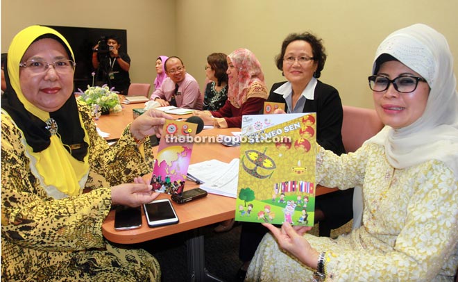 Fatimah (right) receives Seameo Sen brochures from Dr Yasmin during the courtesy visit. — Photo by Jeffery Mostapa