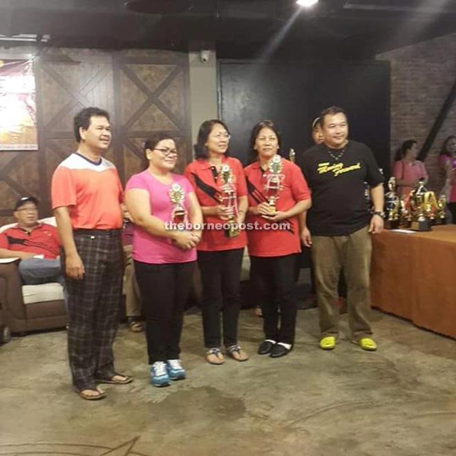 Ik Pahon (left) with the champion women bowlers and Aloysius.