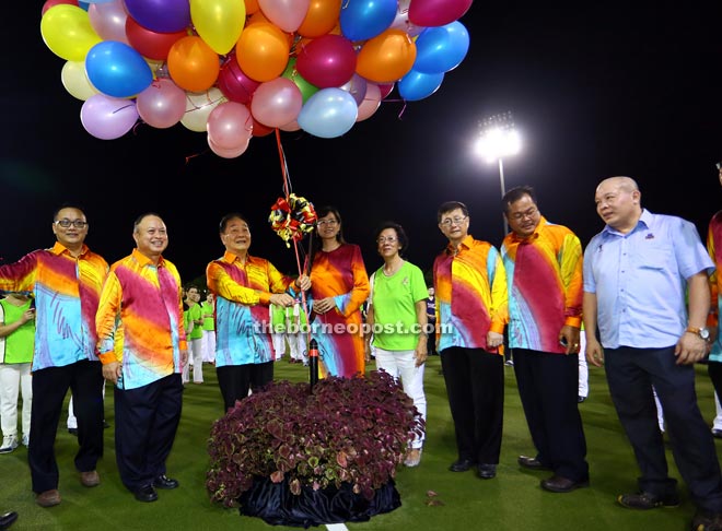 Wong (third from left) launches the Folk Dance Display at the Sarawak Hockey Stadium in Kuching.