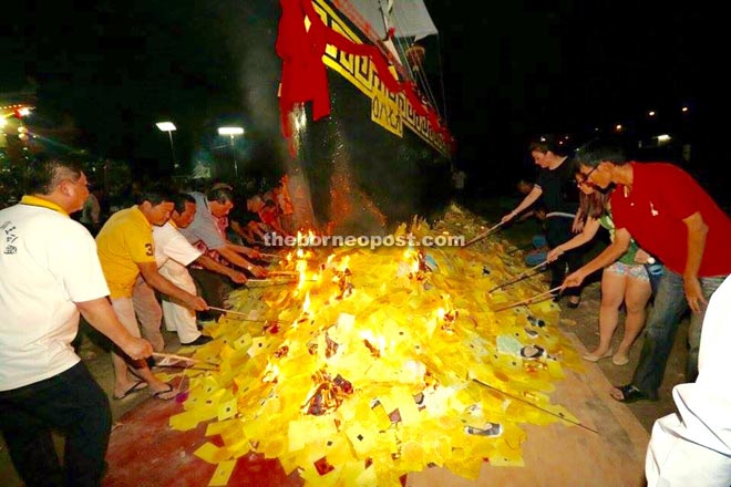 The burning of the paper Chinese junk at Er Par Hwang Temple near Deshon Road.