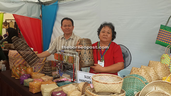 Lumat (right) showing off her Iban woven handicrafts at the venue of the 2015 Sarawak Craft Festival yesterday.