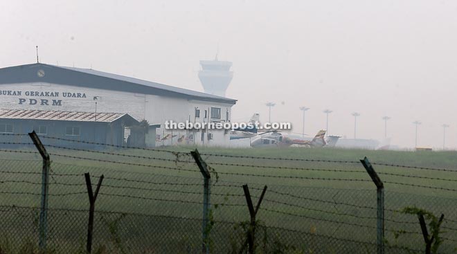 The visibility of Kuching International Airport’s (KIA) control tower is affected by the worsening haze condition. — Photos by Chimon Upon