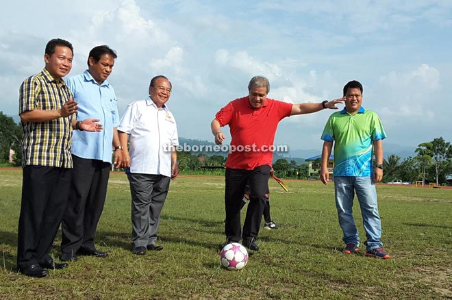 Awang Tengah about to kick the ball to kick-off the Lawas Football League at Lawas Stadium last Sunday. 