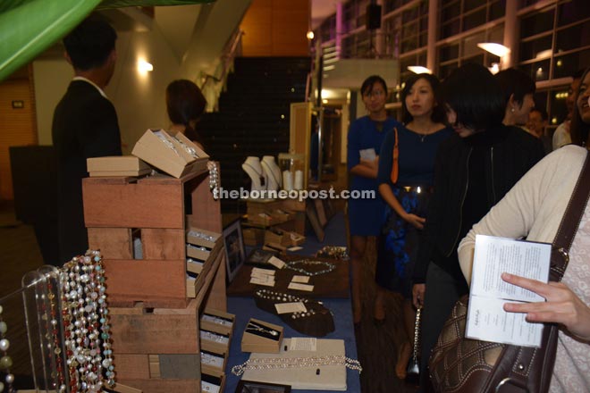 Guests browse through jewellery on display at the Left & Right stall.