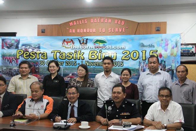 (From left) Paul, Inting and Sabri together with other officers posing for a camera against the backdrop the the festival’s poster.