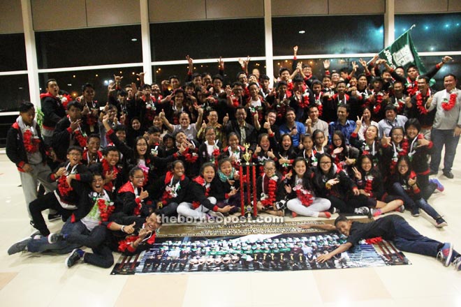 Abd Karim (seated seventh right), Dr Sim (sixth right) and Ling (second right) with accompanying teachers and members of the SJS Marching Band at KIA. ­­— Photos by Jeffery Mostapa