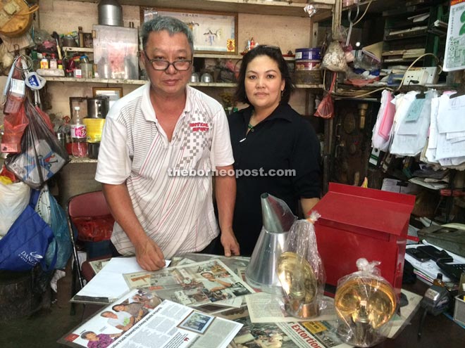 Tinsmith Ho Chin Hin and wife Chan Gek Kiak at their shop.