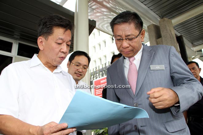 David (left) briefly goes through the proposal with Azmi. Chong is at the centre. — Photo by Chimon Upon