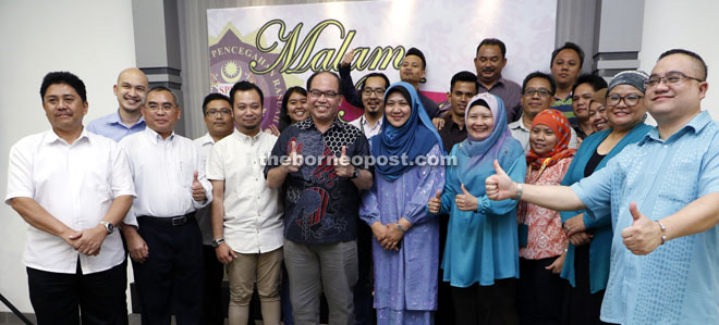 Badul (front row, fourth left) giving the thumbs-up together with MACC Sarawak officers during a group photo with members of the media at the MACC Sarawak Appreciate Night on Monday. — Photo by Chimon Upon