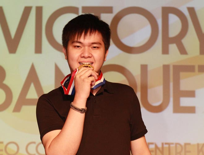 Christopher Tiong displays the gold medal he won in the Men’s Masters in the recent 29th Asian Intercity Bowling Championship in Kuching. — Photo by Teo Chi Wei