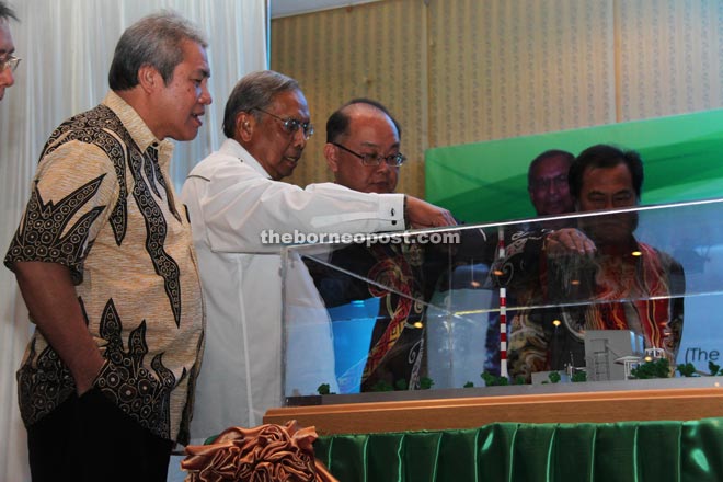 (From left) Awang Tengah, Adenan and others looking at the plan for the Mukah Biomass Power Plant.