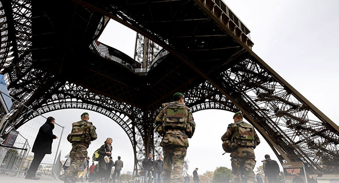 French soldiers patrol the area at the foot of the Eiffel Tower in Paris following a series of coordinated attacks in and around Paris late Friday which left more than 120 people dead. — AFP photo